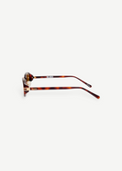 KABE Ambra oval sunglasses with a tortoiseshell frame, slim temples, and gold-tone logo lettering side view