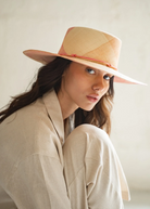 KABE SHOP INC Awisqa hat featuring a woven straw design in soft peach and beige tones with a delicate cord detail.