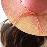 KABE SHOP INC Awisqa hat in pink and natural straw with a delicate knotted cord detail worn by a woman