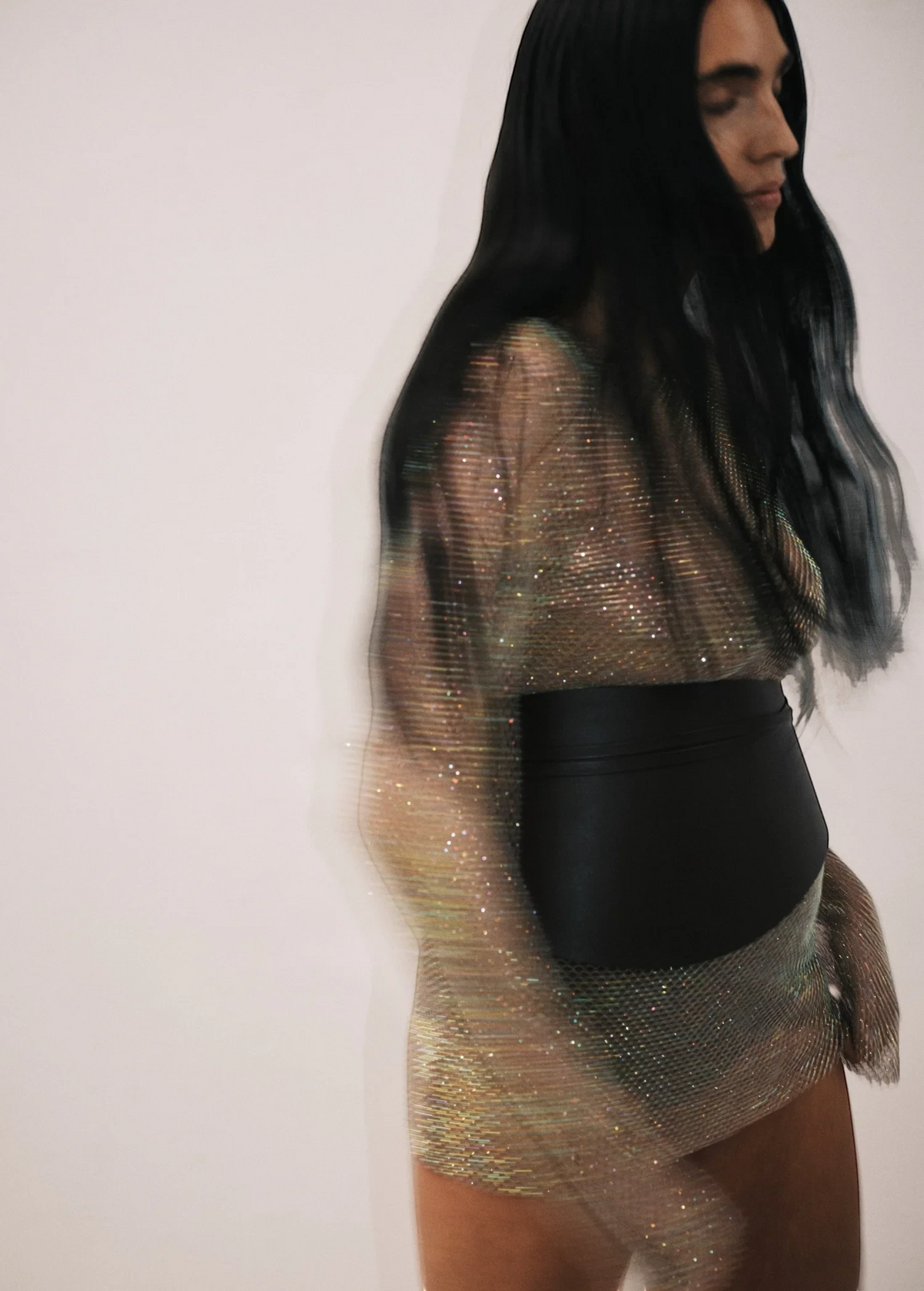 KABE SHOP INC Undone Corset Belt in black calfskin worn over a shimmering metallic mesh dress for a sculpted waist.