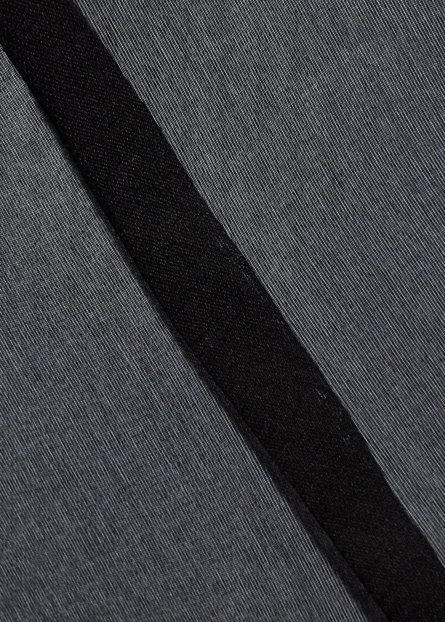Close-up of black 100% silk fabric texture from the KABE SHOP INC Nori Mini Dress showing fine weave and seam detail.