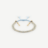 KABE SHOP INC N° 183 braided bracelet in light blue and gold metallic thread with delicate tassel charms