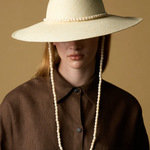 KABE SHOP INC Cajas wide brim straw hat in cream with beaded trim and matching chin strap worn by a model