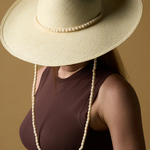 KABE SHOP INC Cajas wide brim straw hat in cream with a decorative beaded chin strap worn by a model