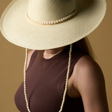 KABE SHOP INC Cajas wide brim straw hat in cream with a decorative beaded chin strap worn by a model