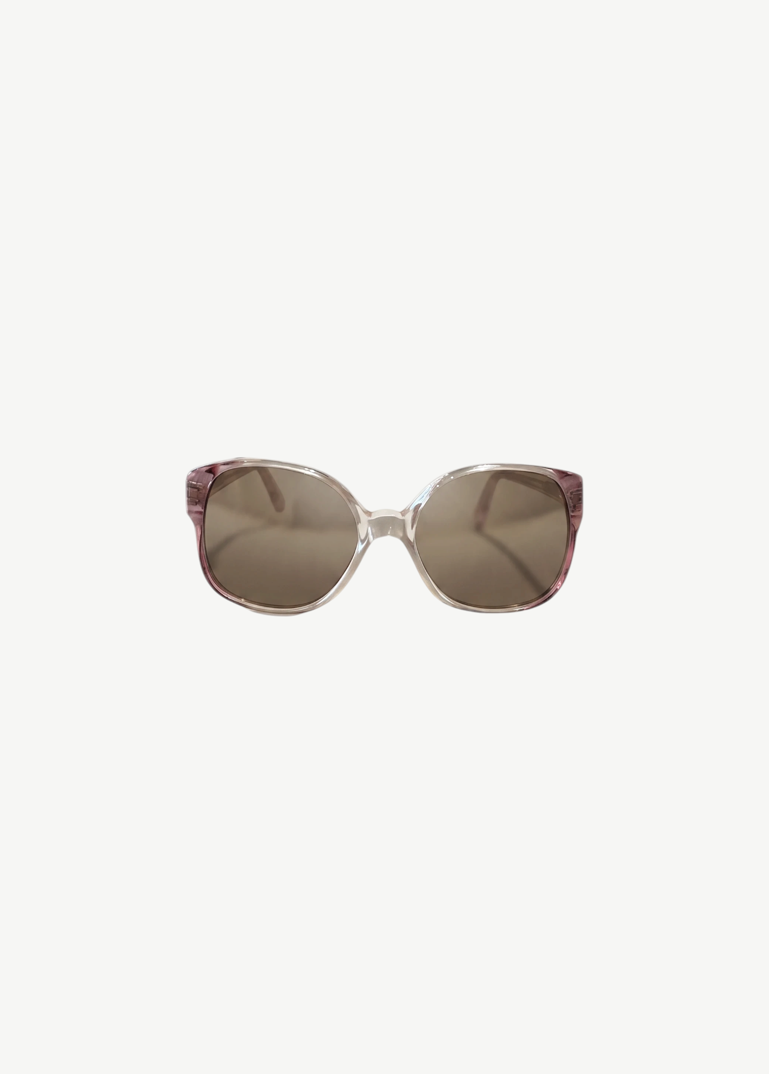 KABE SHOP INC Carven sunglasses featuring translucent pink frames and brown tinted lenses in a classic rounded shape.