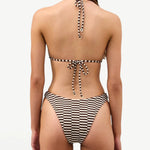 Back view of KABE SHOP INC Cocoa Grid Halter Top featuring a brown and white grid pattern and adjustable tie straps.