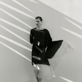 KABE SHOP INC conch shell and freshwater pearl necklace on satin cord worn by a model in a flowing black dress