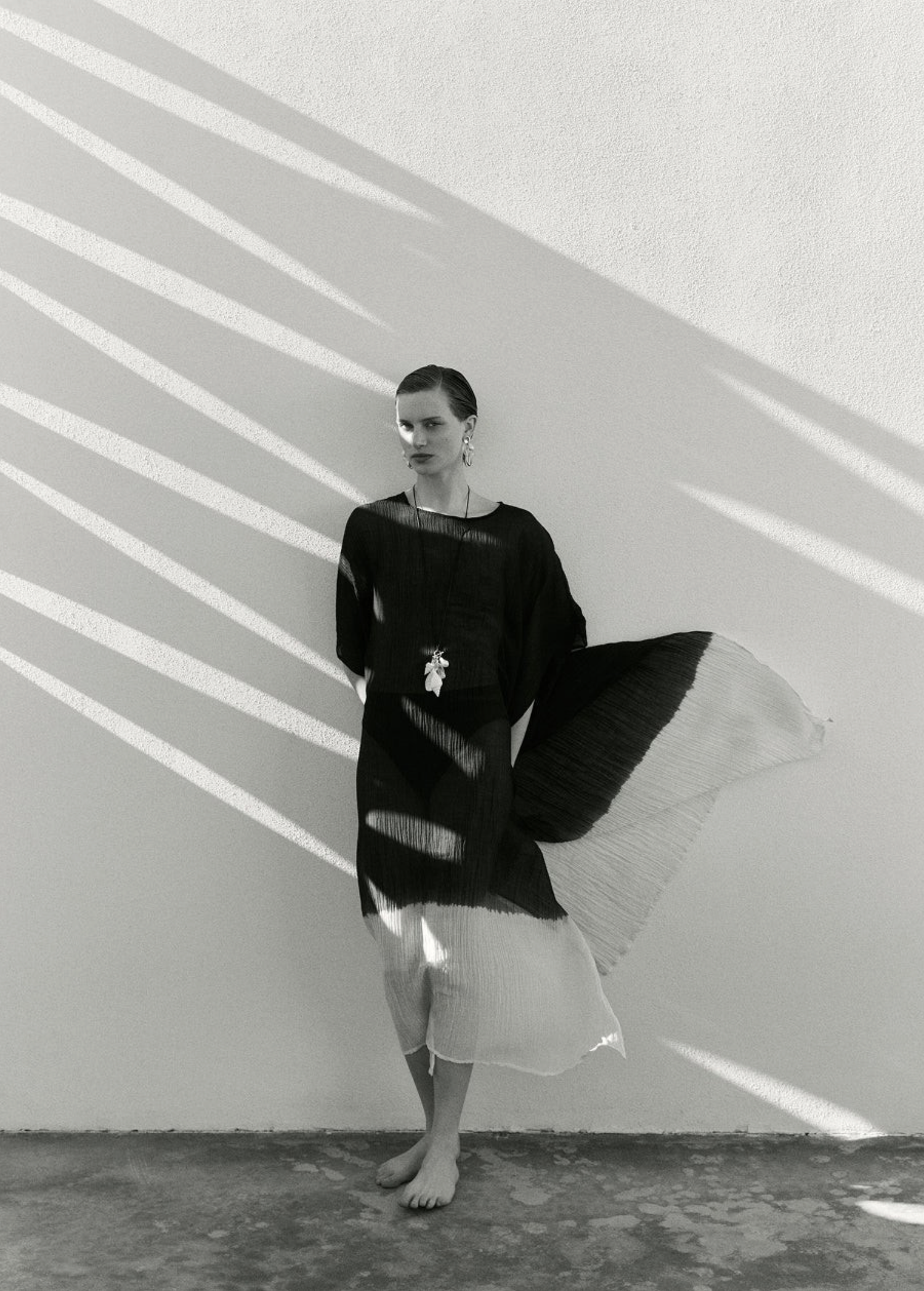 KABE SHOP INC conch shell and freshwater pearl necklace on satin cord worn by a model in a flowing black dress