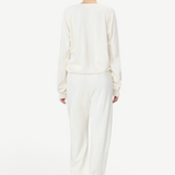 KABE SHOP INC ÉTERNE cream French terry sweatpants on a model, back view showing a relaxed unisex fit.