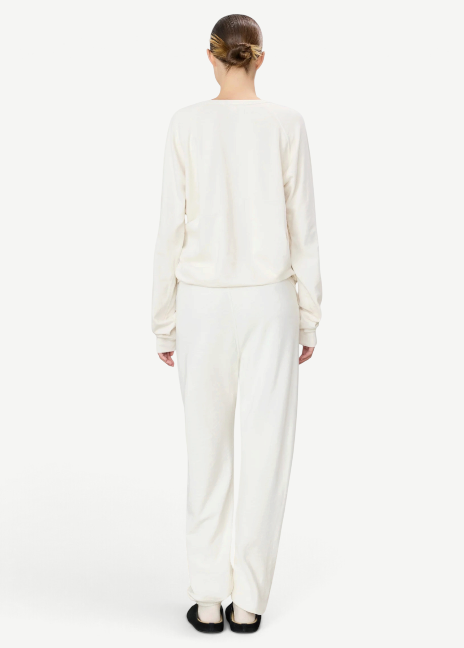 KABE SHOP INC ÉTERNE cream French terry sweatpants on a model, back view showing a relaxed unisex fit.