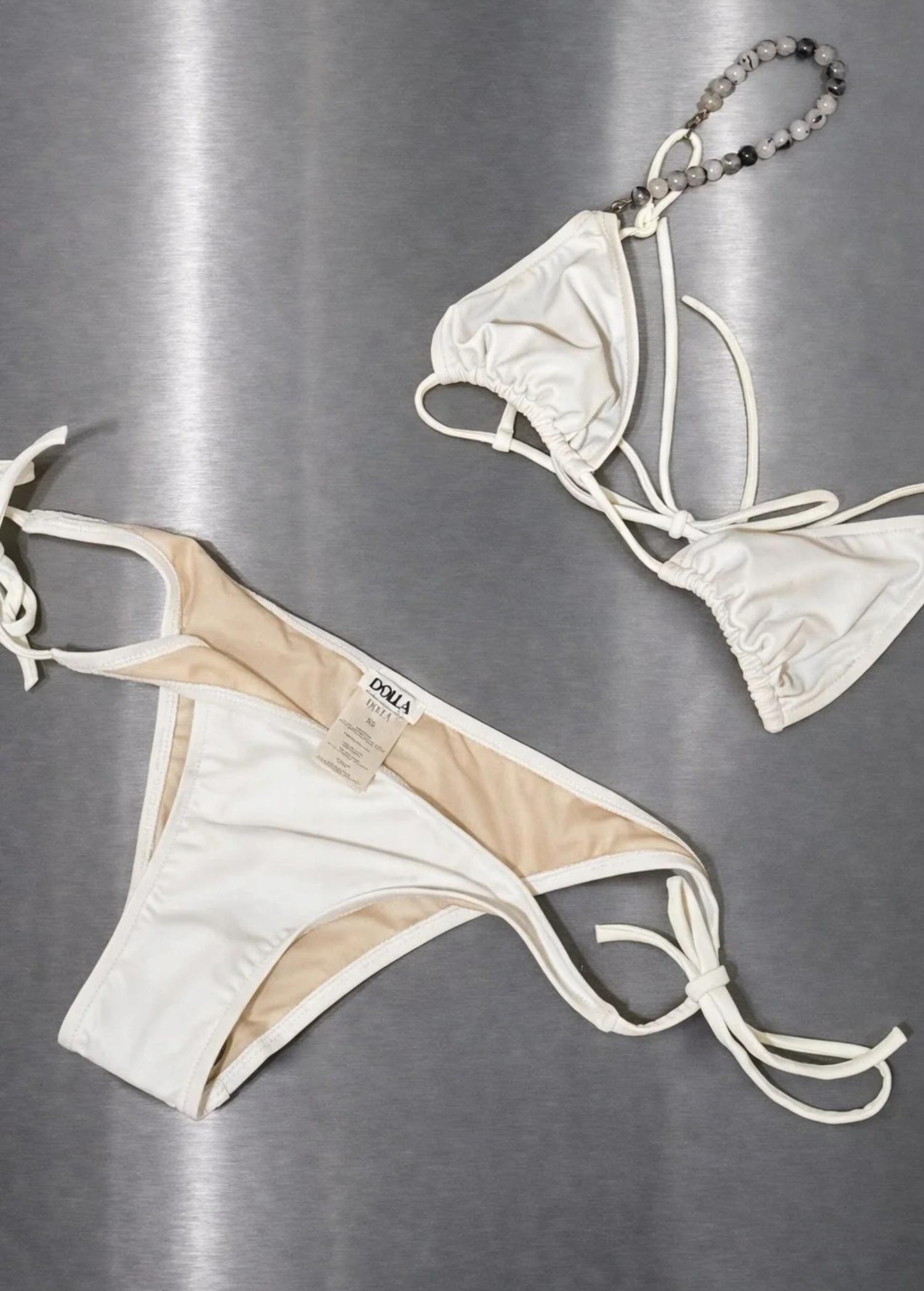 KABE SHOP INC Dolores tie bottom bikini set in white with beaded strap detail on a metallic background