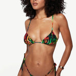 Model wearing KABE SHOP INC Equator Top, a multi-colored tie-dye triangle bikini top with adjustable straps.