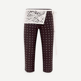 KABE SHOP INC Gianna pants in black with white polka dots, featuring a decorative white crochet waist detail.