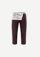 KABE SHOP INC Gianna pants in black with white polka dots, featuring a decorative white crochet waist detail.