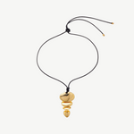 KABE SHOP INC gold sculptural pendant necklace with an adjustable black cord and stacked metallic shapes