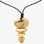 KABE SHOP INC gold sculptural pendant necklace on a black cord, featuring a tiered organic shape design.