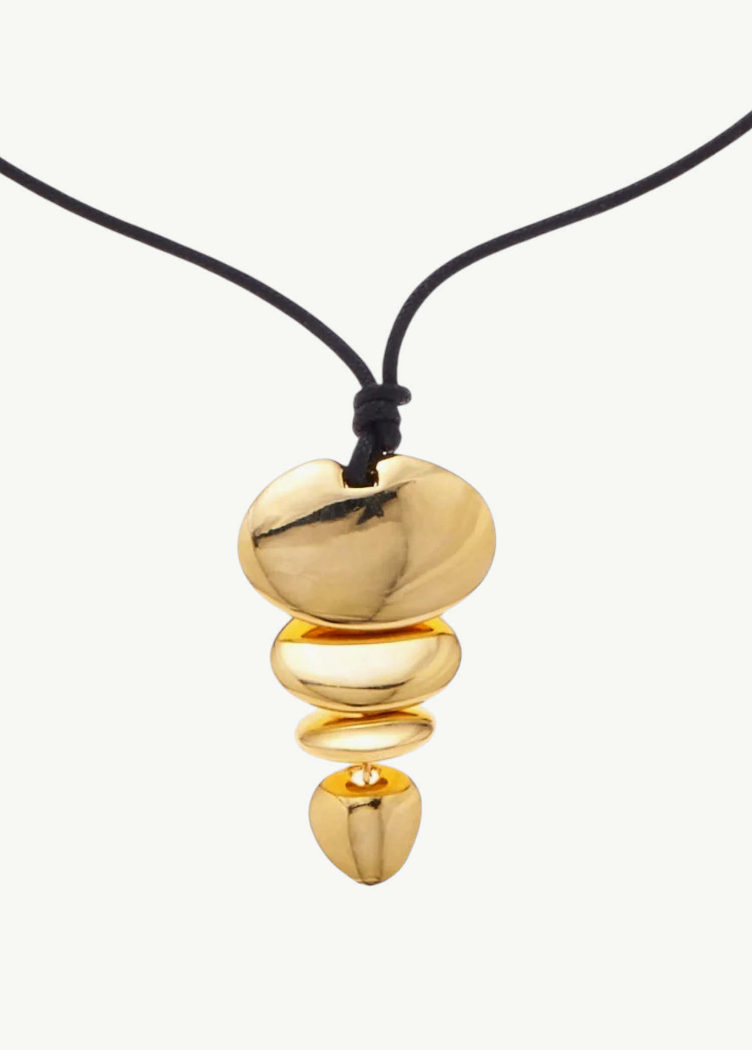 KABE SHOP INC gold sculptural pendant necklace on a black cord, featuring a tiered organic shape design.