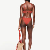 KABE SHOP INC Infinity Top in terracotta, a sculpting bikini top worn by a model from the back view.