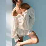 KABE SHOP INC Isabella jumpsuit in white cotton with off-the-shoulder neckline, lace trim, and loose silhouette.