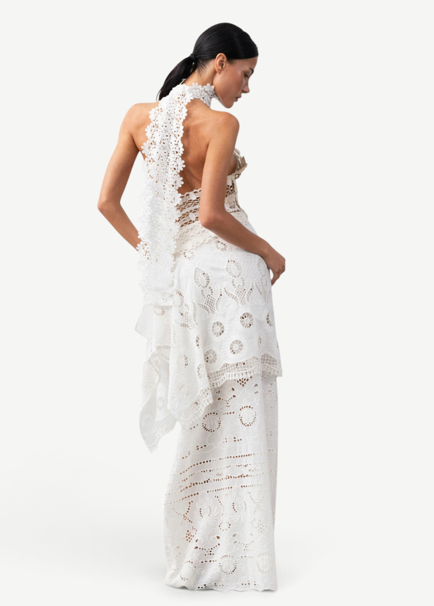 Model wearing a white KABE SHOP INC Katinka skirt featuring intricate crochet and lace patchwork in a fitted style.