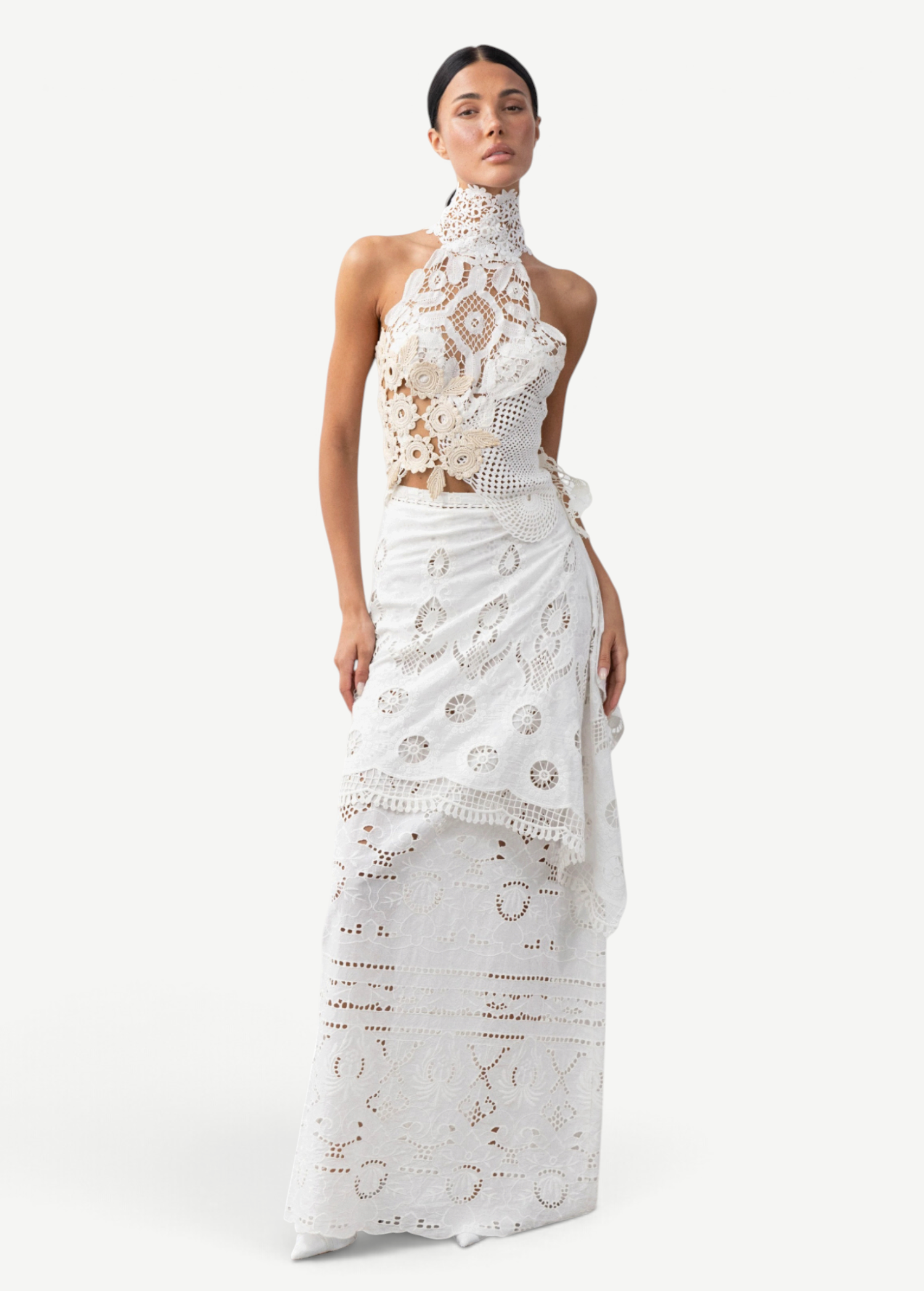 Model wearing a KABE SHOP INC Katinka white cotton skirt with intricate crochet and lace patchwork details.