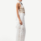 Model wearing KABE SHOP INC Katinka white cotton skirt with intricate crochet and lace patchwork details