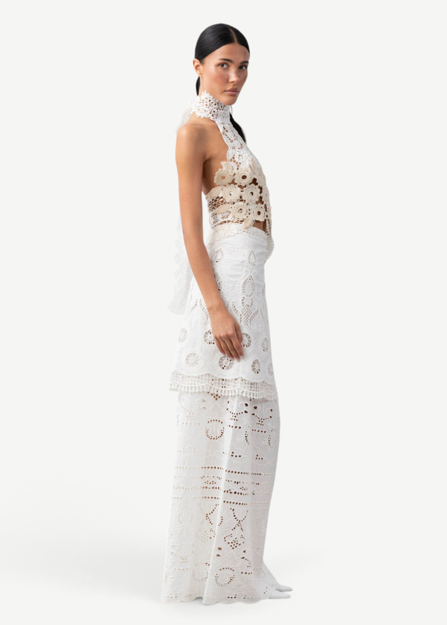 Model wearing KABE SHOP INC Katinka white cotton skirt with intricate crochet and lace patchwork details