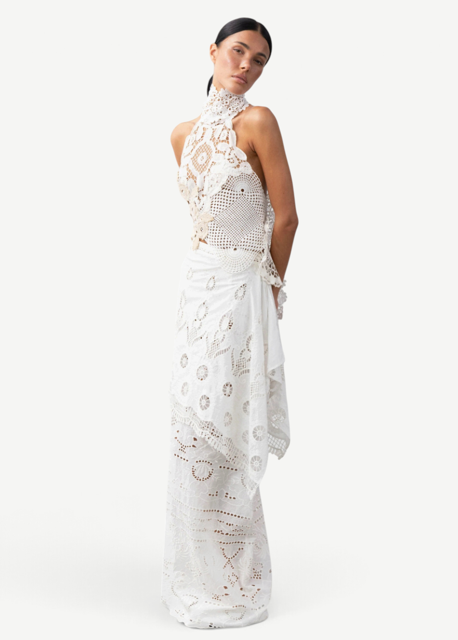 Model wearing a KABE SHOP INC Katinka white cotton skirt with intricate crochet and lace patchwork details.
