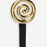 KABE SHOP INC Koru Belt featuring a sculptural gold spiral buckle on a black Italian calfskin leather strap.