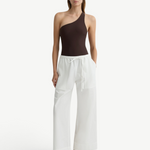 KABE SHOP INC Kyoto wide leg white cotton pants with a drawstring waist worn by a model in a brown one-shoulder top.