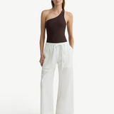 KABE SHOP INC Kyoto wide leg white cotton pants with a drawstring waist worn by a model in a brown one-shoulder top.