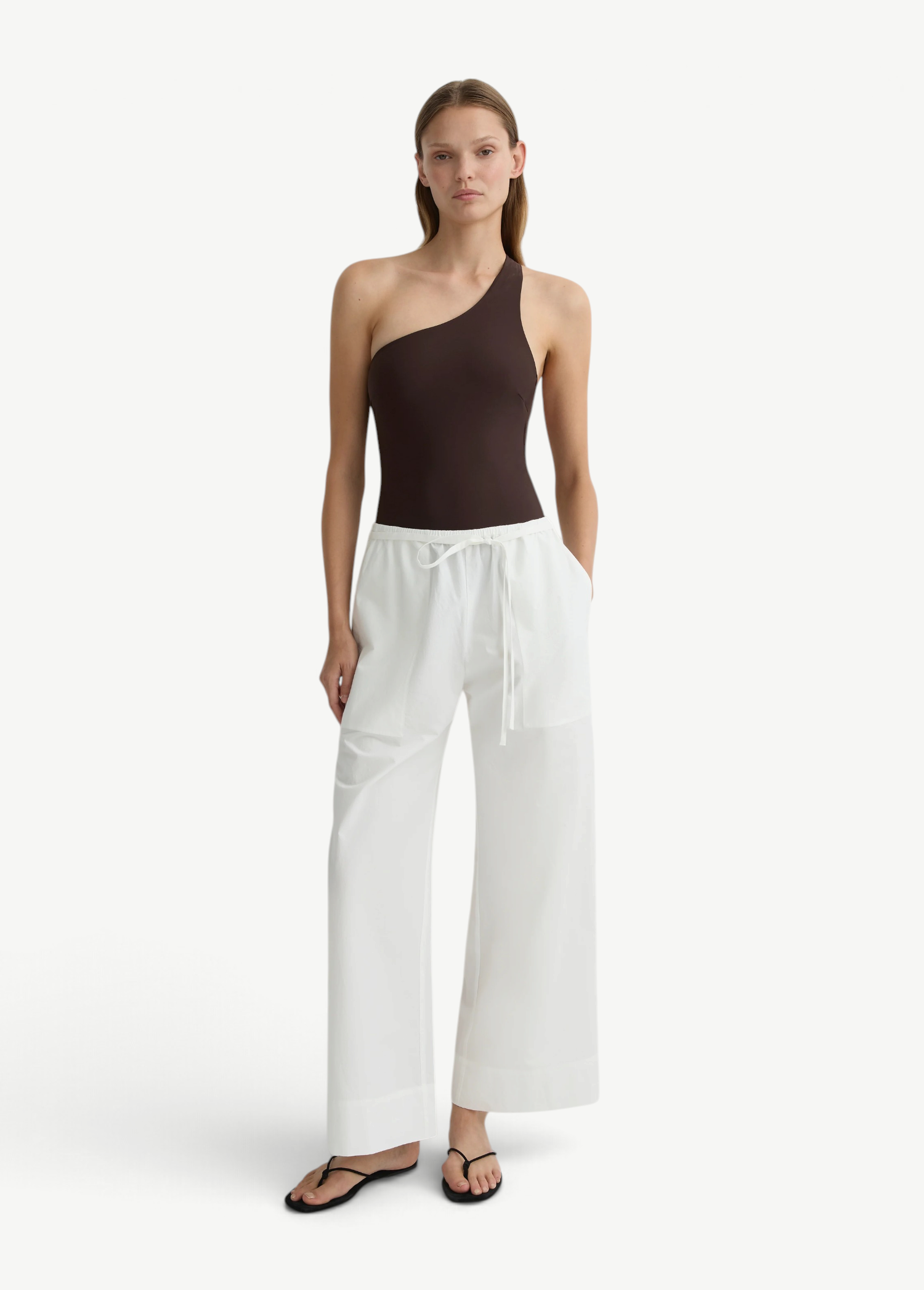 KABE SHOP INC Kyoto wide leg white cotton pants with a drawstring waist worn by a model in a brown one-shoulder top.