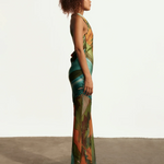 KABE SHOP INC Magdalena long silk maxi dress with halter neckline and abstract landscape print on a model side view