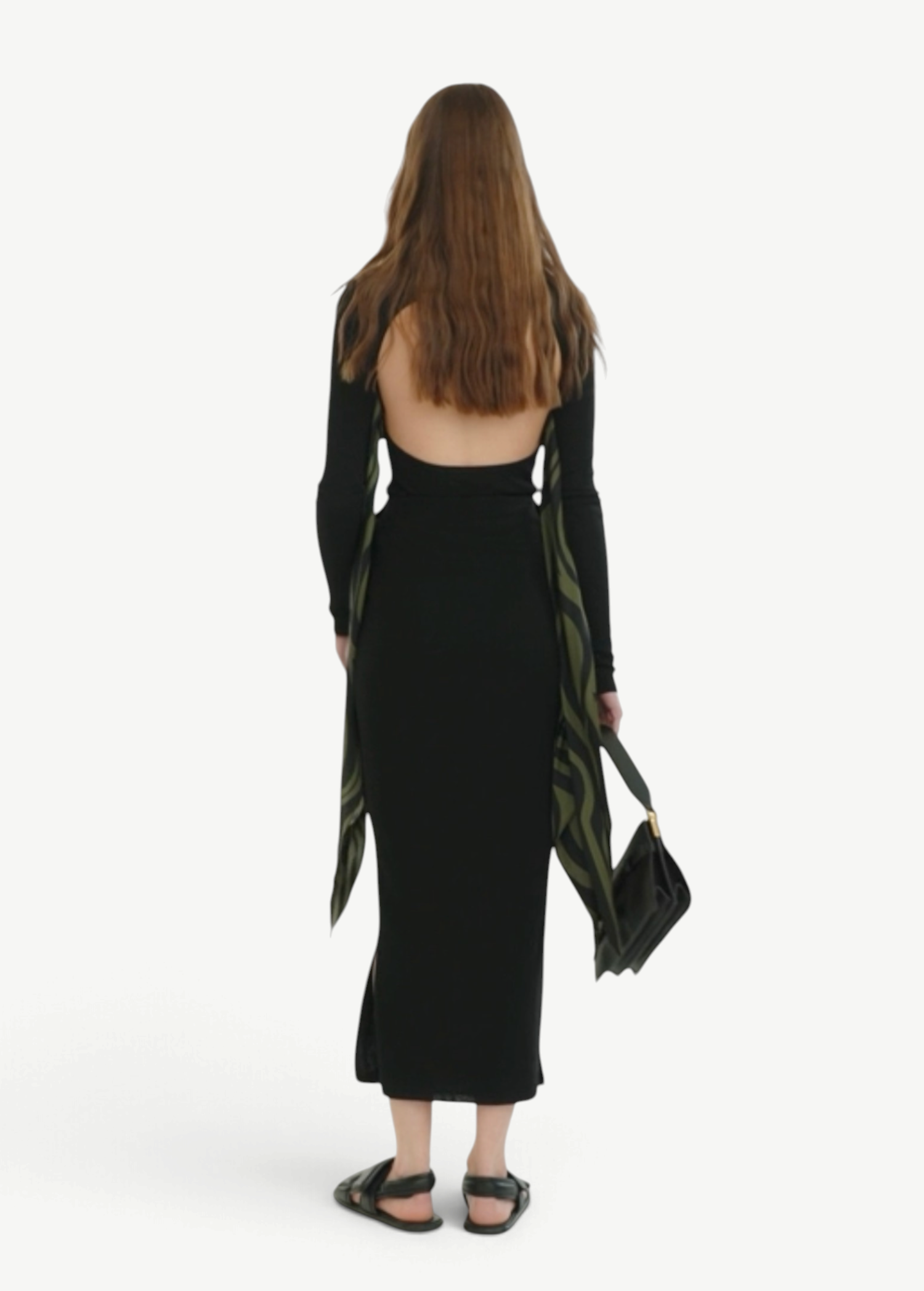 KABE SHOP INC Maltha midi skirt in black, featuring a sculptural silhouette and fluid drape on a model from behind.