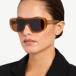 KABE SHOP INC Jacquemus Masco shield sunglasses in caramel acetate with brown lenses worn by a woman in a black blazer