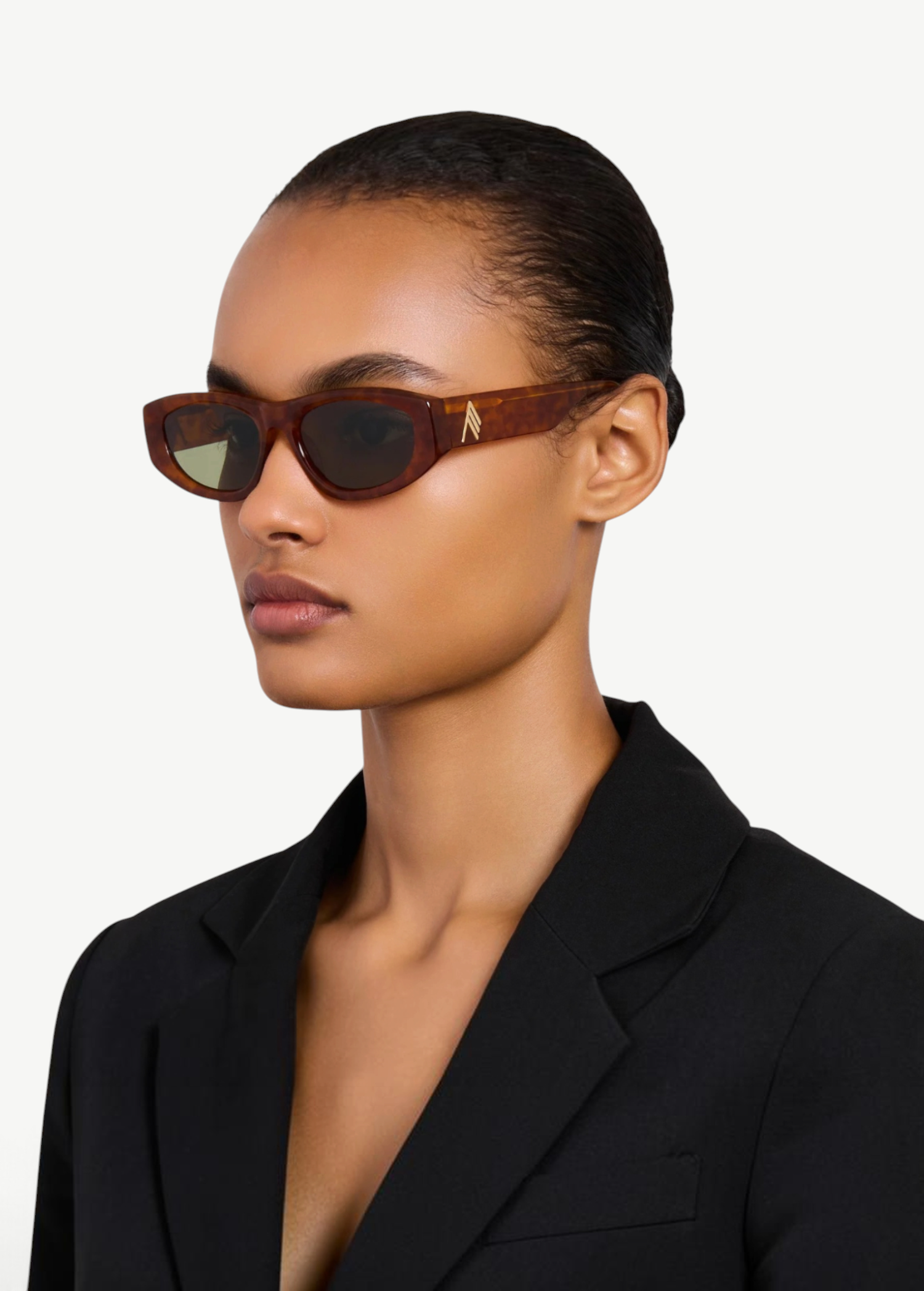 Model wearing KABE SHOP INC Maya sunglasses with a light brown acetate frame and tinted lenses in a side profile view.