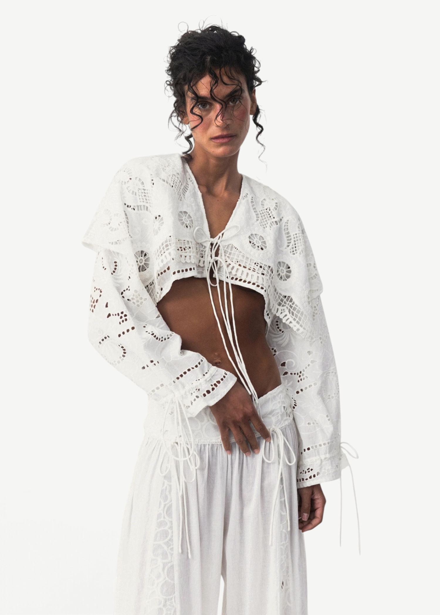 KABE SHOP INC Menorca trousers in white cotton with intricate lace detailing worn by a model in a studio setting