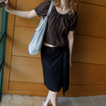 KABE SHOP INC Deiji Studios metallic knit chain bag with drawstring pouch worn by a model in a brown top and skirt