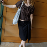 KABE SHOP INC Deiji Studios metallic knit chain bag with drawstring pouch worn by a model in a brown top and skirt