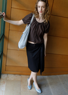 KABE SHOP INC Deiji Studios metallic knit chain bag with drawstring pouch worn by a model in a brown top and skirt
