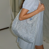 KABE SHOP INC Deiji Studios Chain Bag in metallic silver knit worn over the shoulder with a light blue dress
