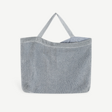 KABE SHOP INC Deiji Studios metallic silver knit shoulder bag with an organic cotton drawstring pouch interior.