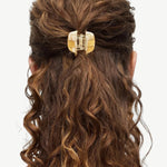 KABE SHOP INC mini claw hair clip in beige Italian bio-acetate holding curly hair in a half-up style