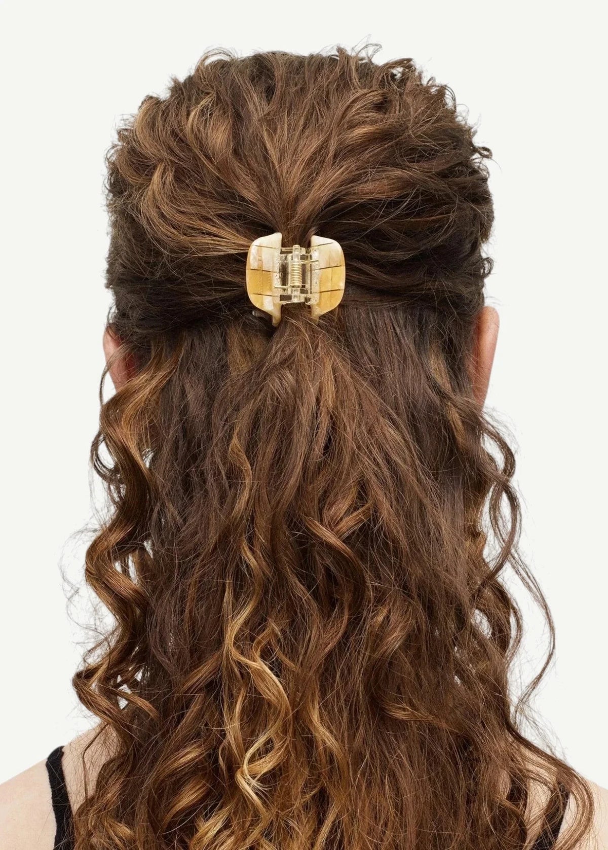 KABE SHOP INC mini claw hair clip in cream and brown bio-acetate holding curly hair in a half-up style