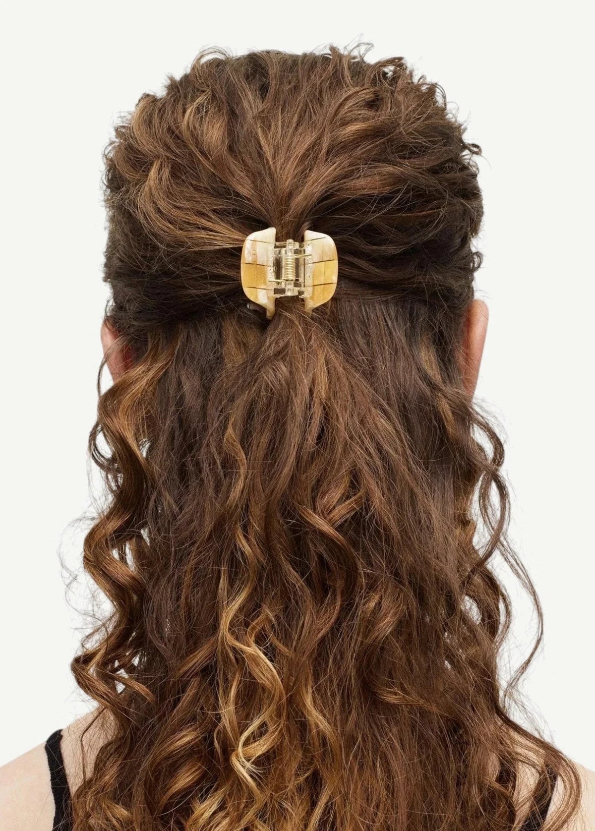 KABE SHOP INC mini claw hair clip in beige Italian bio-acetate holding curly hair in a half-up style