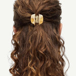 KABE SHOP INC mini claw hair clip in beige Italian bio-acetate holding curly hair in a half-up style