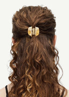KABE SHOP INC mini claw hair clip in beige Italian bio-acetate holding curly hair in a half-up style
