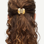 KABE SHOP INC mini claw hair clip in beige Italian bio-acetate holding curly hair in a half-up style