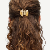 KABE SHOP INC mini claw hair clip in beige Italian bio-acetate holding curly hair in a half-up style